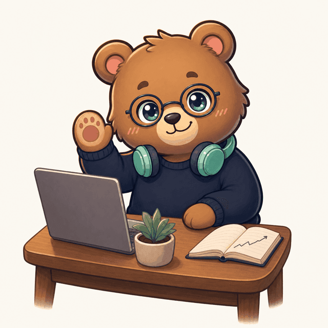 デスクで手を振るクマのマスコット